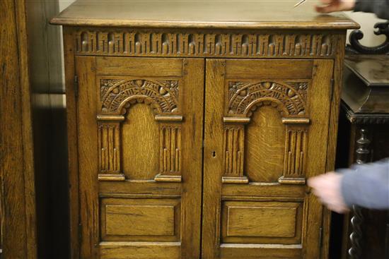 A carved and panelled oak wardrobe fitted two doors with matching compactum and dressing table, wardrobe W.104cm, D.55cm, H.178cm